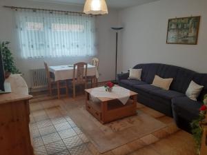 a living room with a couch and a table at Ferienapartment Karle in Nordrach