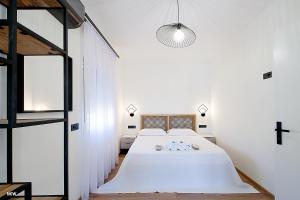 a bedroom with a large bed and a cross on the wall at Georgia apartments in town in Skiathos Town