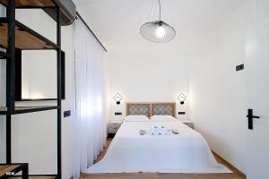 a bedroom with a large bed and a cross on the wall at Georgia apartments in town in Skiathos
