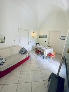 a living room with a bed and a table at Victoria Apt - Historical Centre Lecce in Lecce