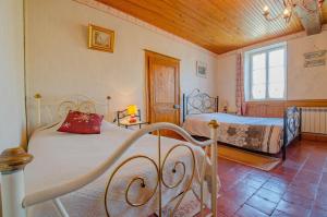 a bedroom with two beds and a window at La germ'alice in Briel-sur-Barse