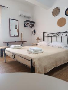 a bedroom with two beds with towels on them at Pension Ilias - Chora Amorgos in Amorgos