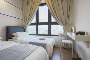 a hotel room with two beds and a window at M Vertica KL Residence in Kuala Lumpur