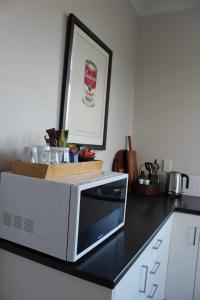 a microwave sitting on top of a kitchen counter at The Suite - Huntly House in Auckland