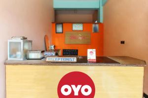 a counter with an ovo sign on it at OYO 92908 Hotel Jayanni in Labu Sumbawa