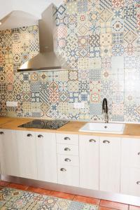 a kitchen with a sink and tiles on the wall at El Patio de los Naranjos in Guadalupe