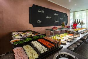 a buffet line with many different types of food at Mercury Hotel- All Inclusive in Sunny Beach