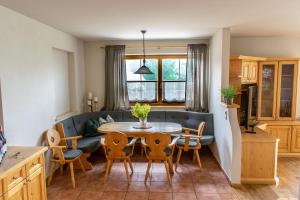 a kitchen and living room with a table and chairs at Weinzeit Chalet & Appartements in Königsleiten