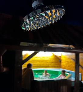 a group of people in a swimming pool at night at Filargo Apartmans - Cazare Sovata in Sovata