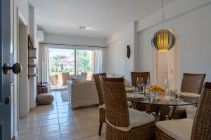 a dining room with a table and chairs and a living room at Tropical Paradise in Harbour Paphos, Central & Close to Beach in Paphos City +21 photos