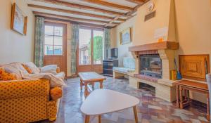a living room with a couch and a fireplace at Le gite de la faiencerie in Dival