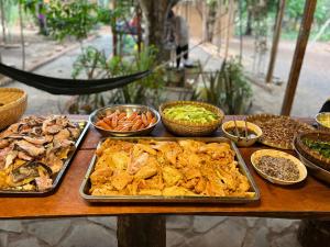 a table with many different types of food on it at Gạo Farmstay in Ấp Vĩnh An Số
