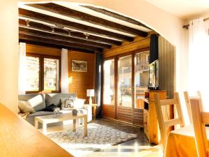 a living room with a couch and a table at Appartement au cœur de La Clusaz (50m des pistes) in La Clusaz