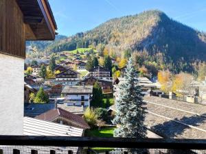 a view of a town with a christmas tree at Appartement au cœur de La Clusaz (50m des pistes) in La Clusaz
