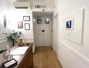 an office with a hallway with white walls and wood floors at INTERNO ROMA in Rome