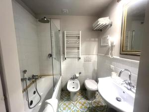 a bathroom with a sink and a toilet and a shower at INTERNO ROMA in Rome
