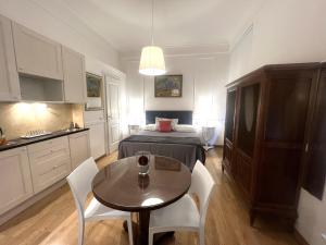 a small room with a bed and a table and chairs at INTERNO ROMA in Rome +21 photos