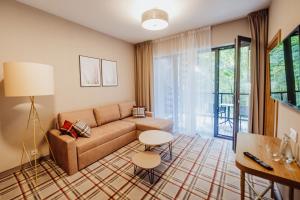 uma sala de estar com um sofá e uma mesa em Green Apartments Wilcza em Karpacz