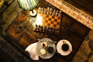 a table with a chess board and a cup of coffee at Regency House in Belfast