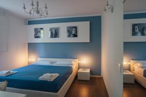 a bedroom with blue walls and a bed with blue sheets at Locanda Dolcevita in Dozza