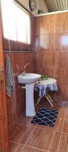 a bathroom with a sink and a table at Kallabaskop Eco lodge in Soebatsfontein