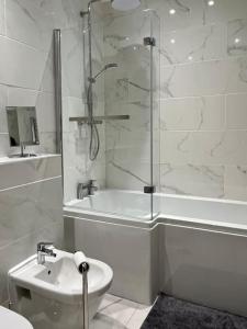 a bathroom with a shower and a toilet and a sink at The Lytham Cottage in Lytham St Annes