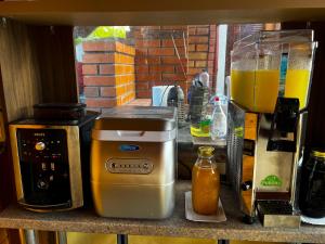 a kitchen counter with a blender and a drink at Filargo Apartmans - Cazare Sovata in Sovata +37 photos