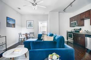 uma sala de estar com um sofá azul e uma mesa em CozySuites Music Row Charming 1BR free parking 49 em Nashville
