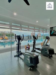 a gym with two treadmills and a swimming pool at Ipoh D Festivo Suites 6-10pax 10mins to Sunway Tambun by IWH in Ipoh