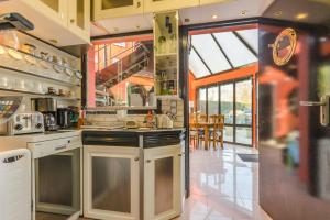 a kitchen with an island in the middle at Le tiki beach in Buchères