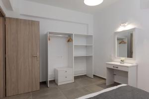 a bathroom with a sink and a mirror at Michaela's Apartment in Koskinou +8 photos