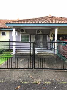 a black fence in front of a house at Riqayraa Muslim Homestay in Seremban