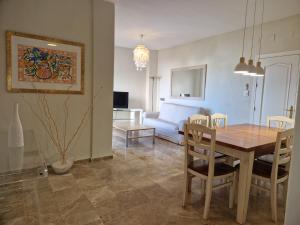 a dining room and living room with a table and chairs at MARBELLA - MIJAS in Mijas