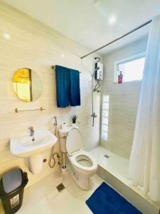 a bathroom with a toilet and a sink at CityCenter Queen-Bed Room w Panoramic Skyline View in Naga