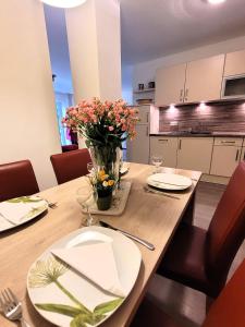 a dining room table with a vase of flowers on it at Winterberg Appartement 21085 in Winterberg
