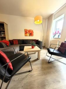 a living room with a couch and a table at Winterberg Appartement 21085 in Winterberg