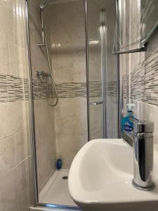 a bathroom with a shower and a sink and a shower at Amazing Studio Room in Ilford! in Ilford