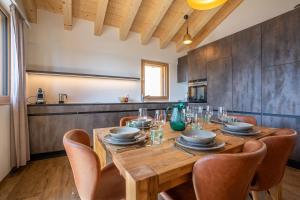 a dining room with a wooden table and chairs at Vieux Valais BeeValais 1 in Riederalp