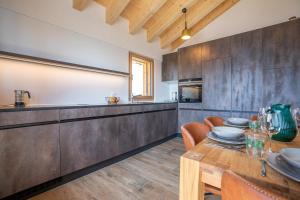a kitchen and dining room with a wooden table at Vieux Valais BeeValais 1 in Riederalp