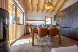 a kitchen with a wooden table and chairs at Vieux Valais BeeValais 1 in Riederalp