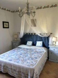 a bedroom with a bed with a blue comforter at Villa at Tuscany border, swimming pool, golfcourse in Tarquinia