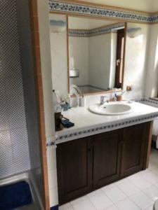 a bathroom with a sink and a mirror at Villa at Tuscany border, swimming pool, golfcourse in Tarquinia