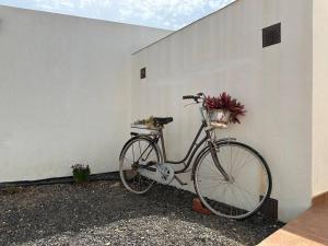 a bike parked next to a white wall with a basket at Private villa with pool in the mountains in Pájara