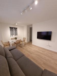 a living room with a couch and a table at Apartamentos Encanto Mudéjar in Teruel