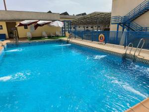 a large blue swimming pool in front of a hotel at Acceso Sevilla Piscina Moderno Parking Gratis in Bormujos