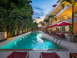 勒吉安的住宿－Anantara Vacation Club Legian，一个带桌椅的度假村游泳池