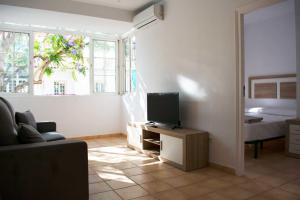 een woonkamer met een televisie en een bed bij Vacation rental Fuengirola in Fuengirola