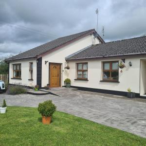 a white house with a driveway at Gurrane House in Galway