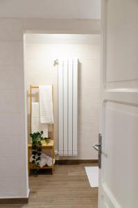 a bathroom with a mirror and a towel rack at Modern Stone Apartment in the Heart of Bari in Bari