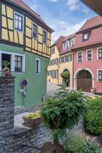 a row of colorful buildings in a street at Schuler-Petschler in Obereisenheim